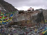 Tibet Kailash 09 Kora 08 Dolma Rock on Dolma La The surfaces of the Dlma Do (Dlmas Rock) are inscribed with mantras in yellow and red. When Gotsangpa wandered into the valley of Dakini Khadroma, he was led back to the correct route by 21 wolves that were 21 emanations of Dlma (Tara), the goddess of mercy and protectoress of the pass. Reaching the pass, the 21 wolves merged into one and then merged again into the great rock.